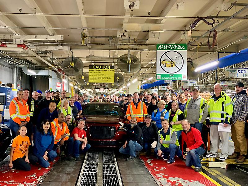 Workers at Stellantis Brampton Assembly Plant gather around the final Chrysler 300C built at the plant in December 2023