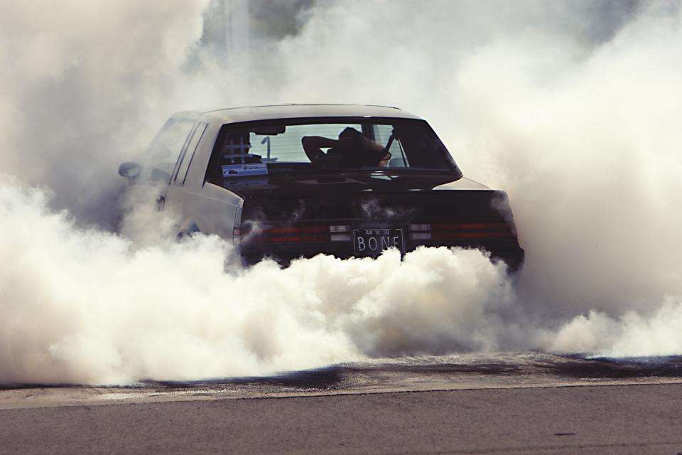 Car doing a burnout surrounded by tire smoke