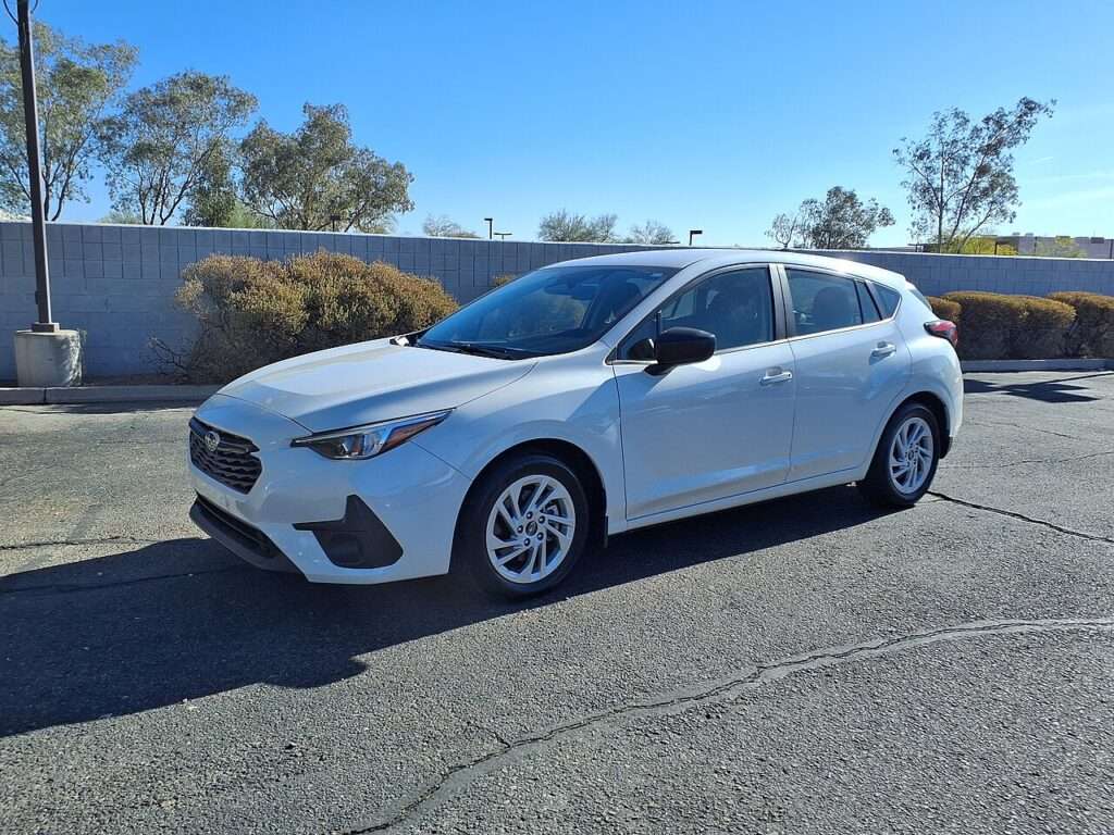 White 2024 Subaru Impreza Base hatchback parked in a lot, the trim Subaru is bringing back for 2027