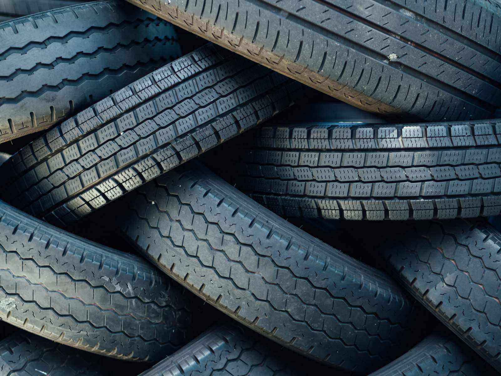 Assorted passenger car tires stacked on racks