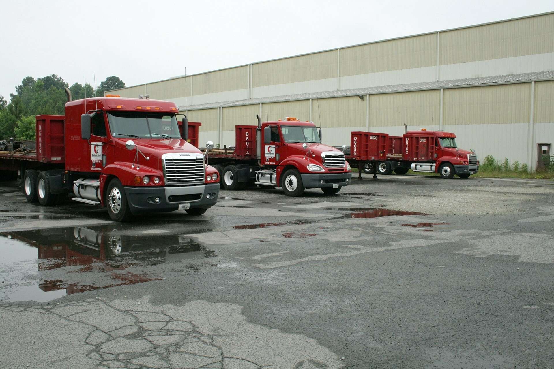 Tractor-trailer trucks parked in a commercial lot