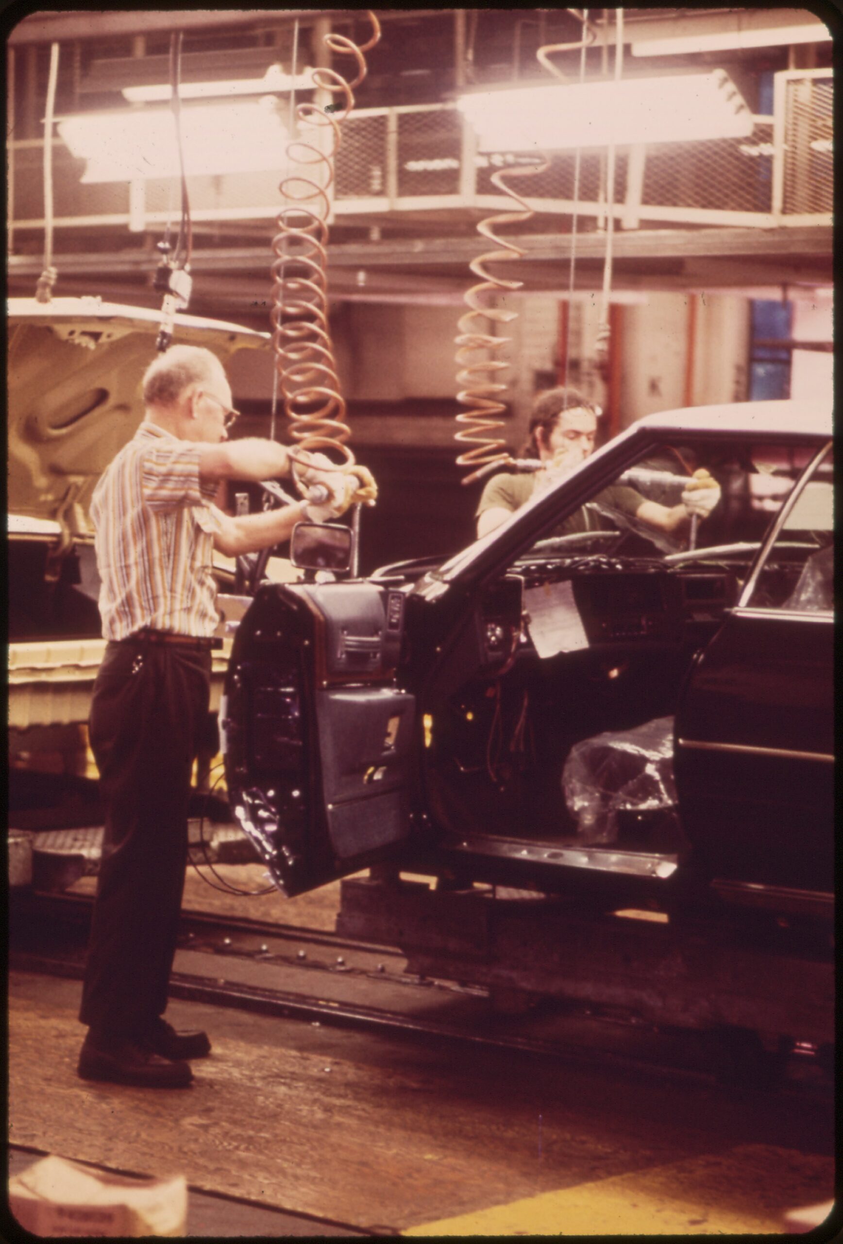 An autoworker installs body wiring on a Cadillac assembly line in Detroit in 1973, three years after the 1970 GM strike