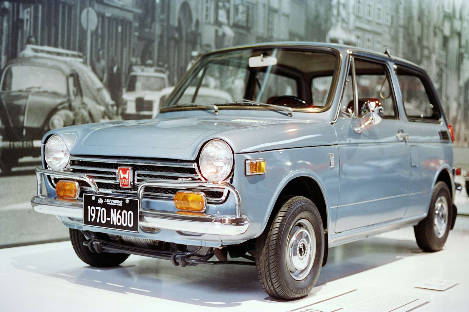 A light blue vintage Honda N600, an early Honda car from the company founded on September 24, 1948