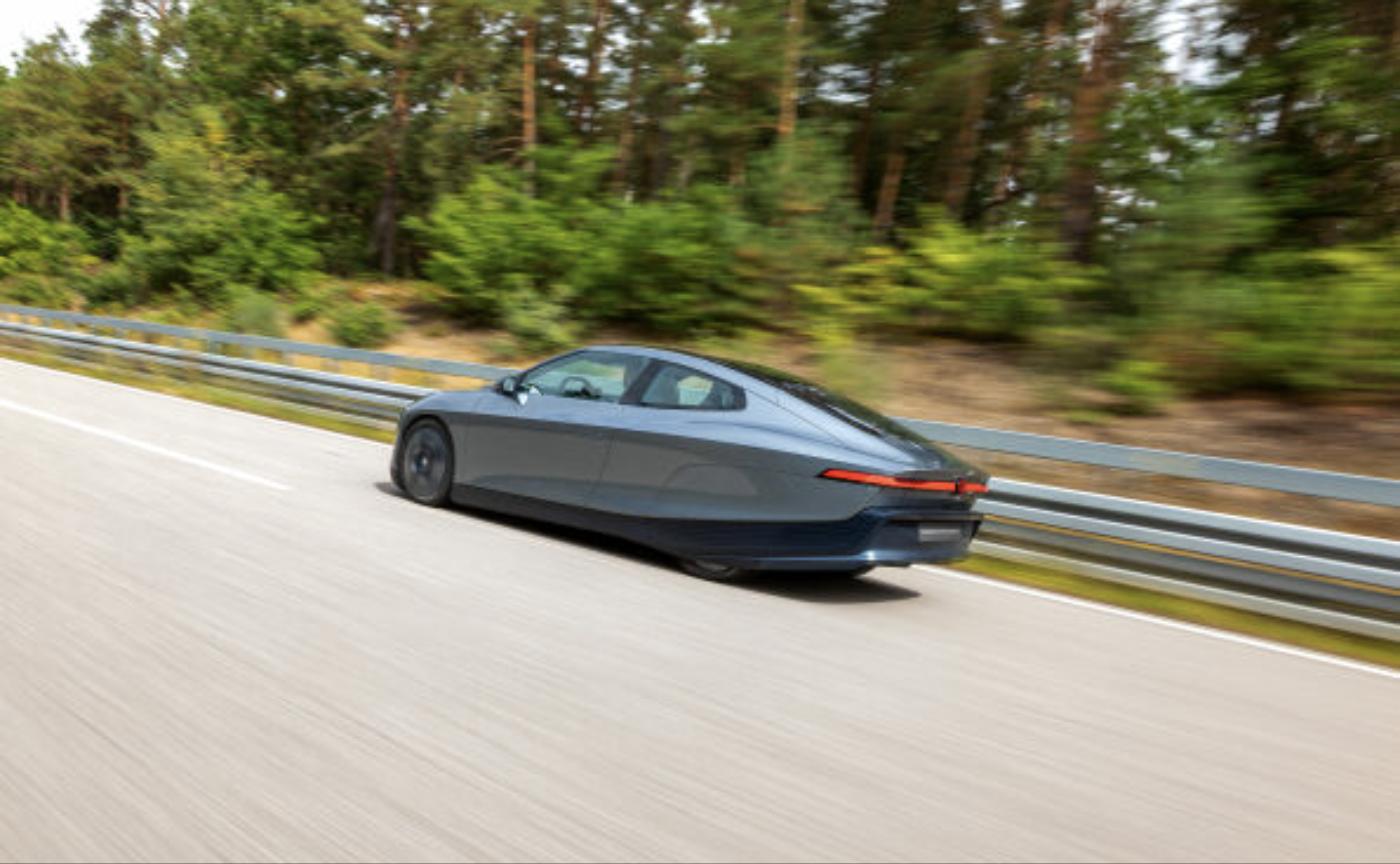 Volkswagen Mission Efficiency prototype driving on a test track, showing its covered rear wheels and teardrop roofline