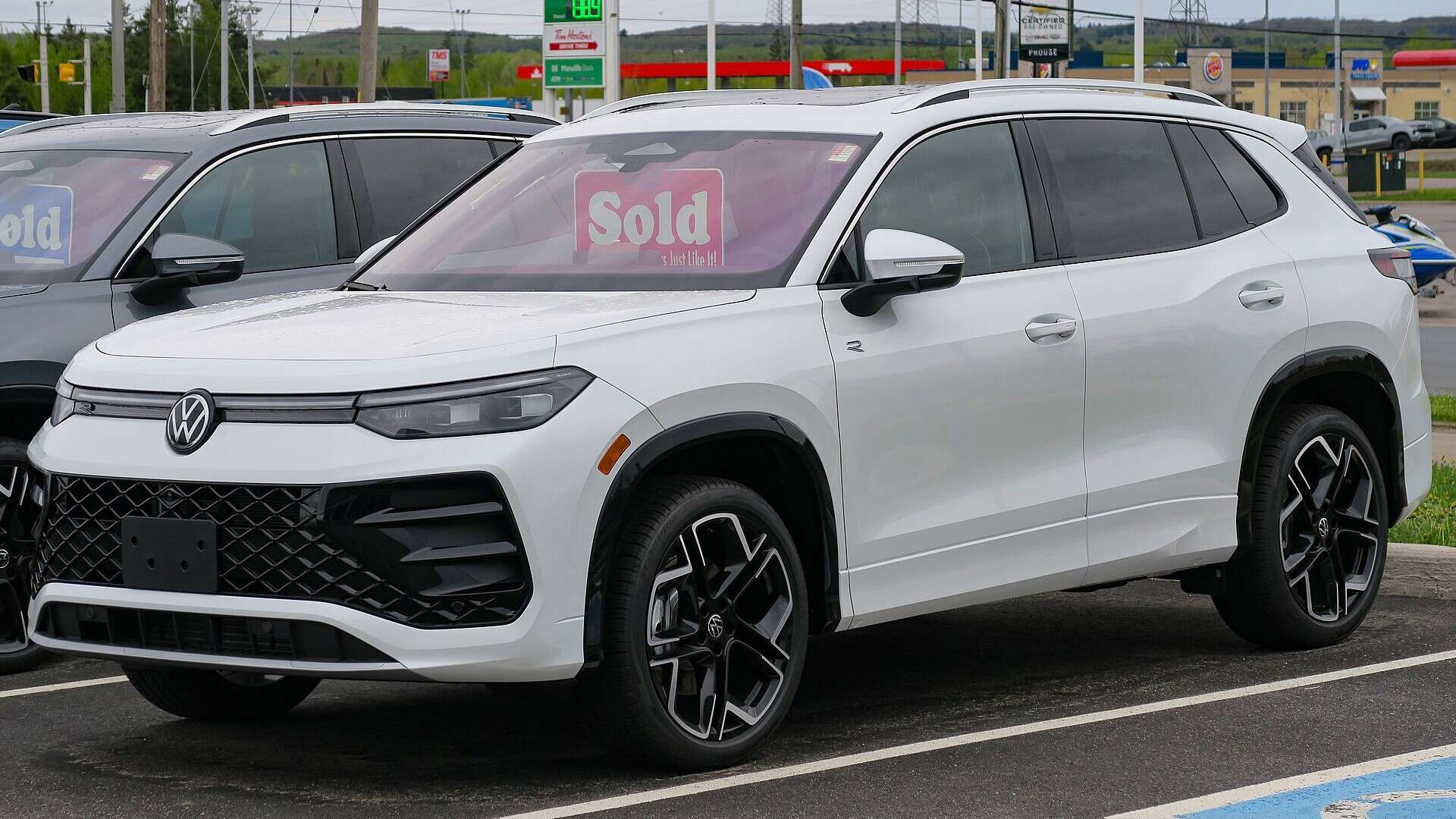 A white 2025 Volkswagen Tiguan R-Line, the long-wheelbase North American version built in Puebla, Mexico