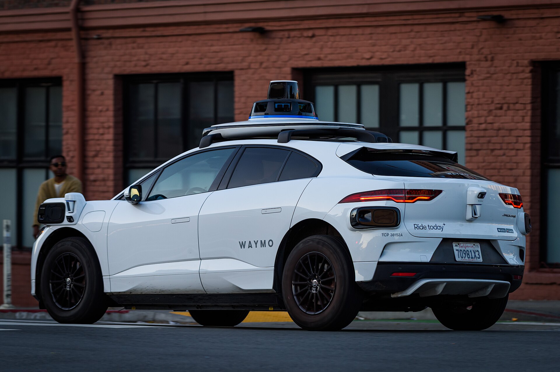 Waymo autonomous robotaxi with roof-mounted sensor array
