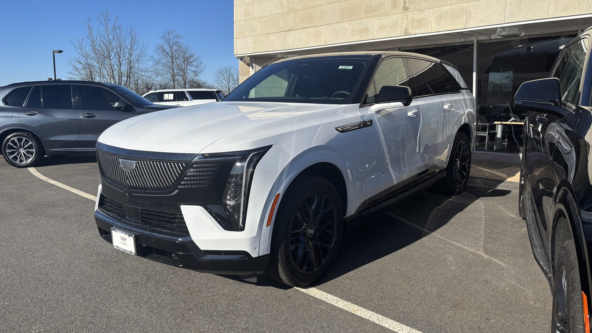 White 2026 Cadillac Escalade IQ electric SUV parked in a lot