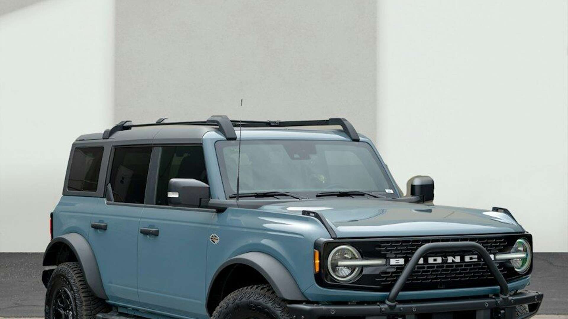 a blue truck parked in a parking lot