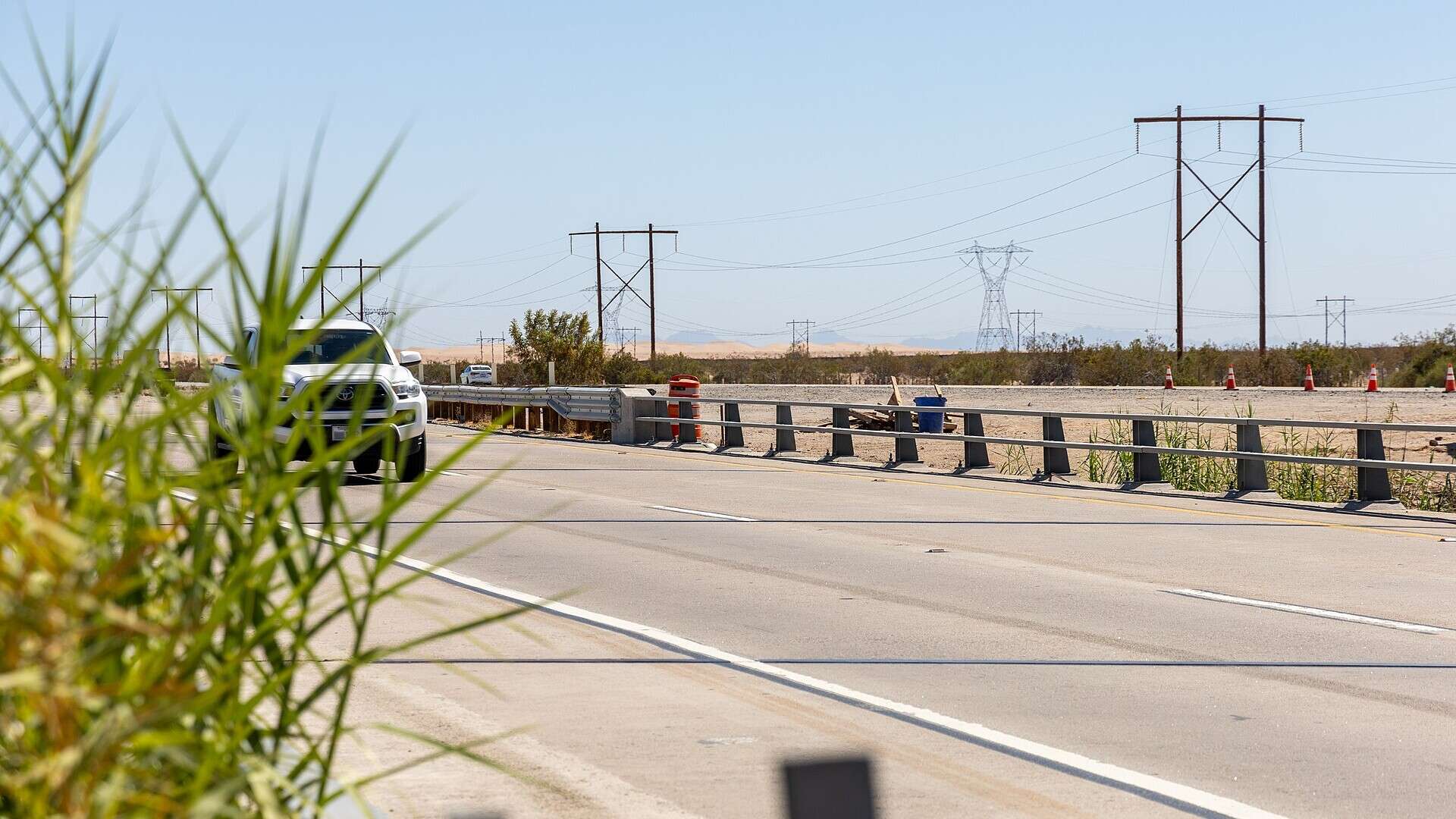License plate reader camera disguised as a traffic barrel beside an interstate