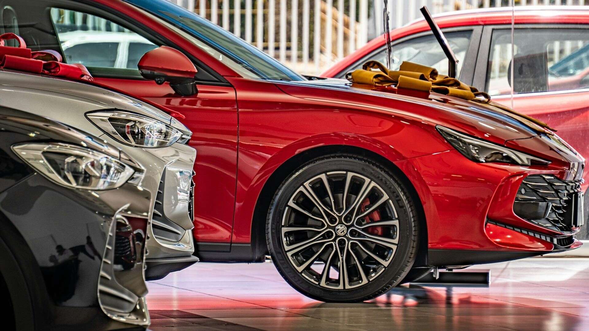 Several new cars parked in a showroom