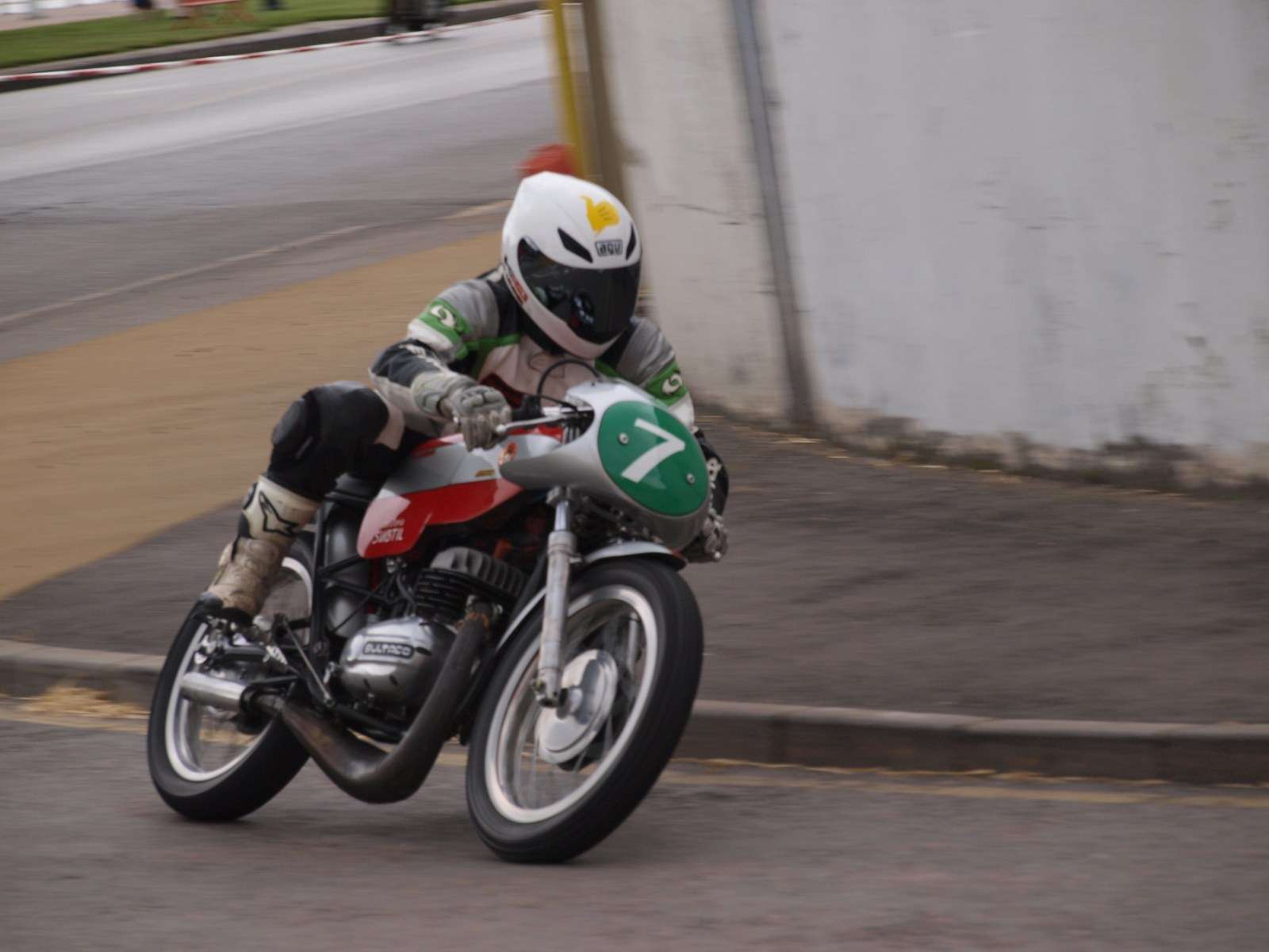 Rider on a vintage 1970s Bultaco racing motorcycle wearing race number 7