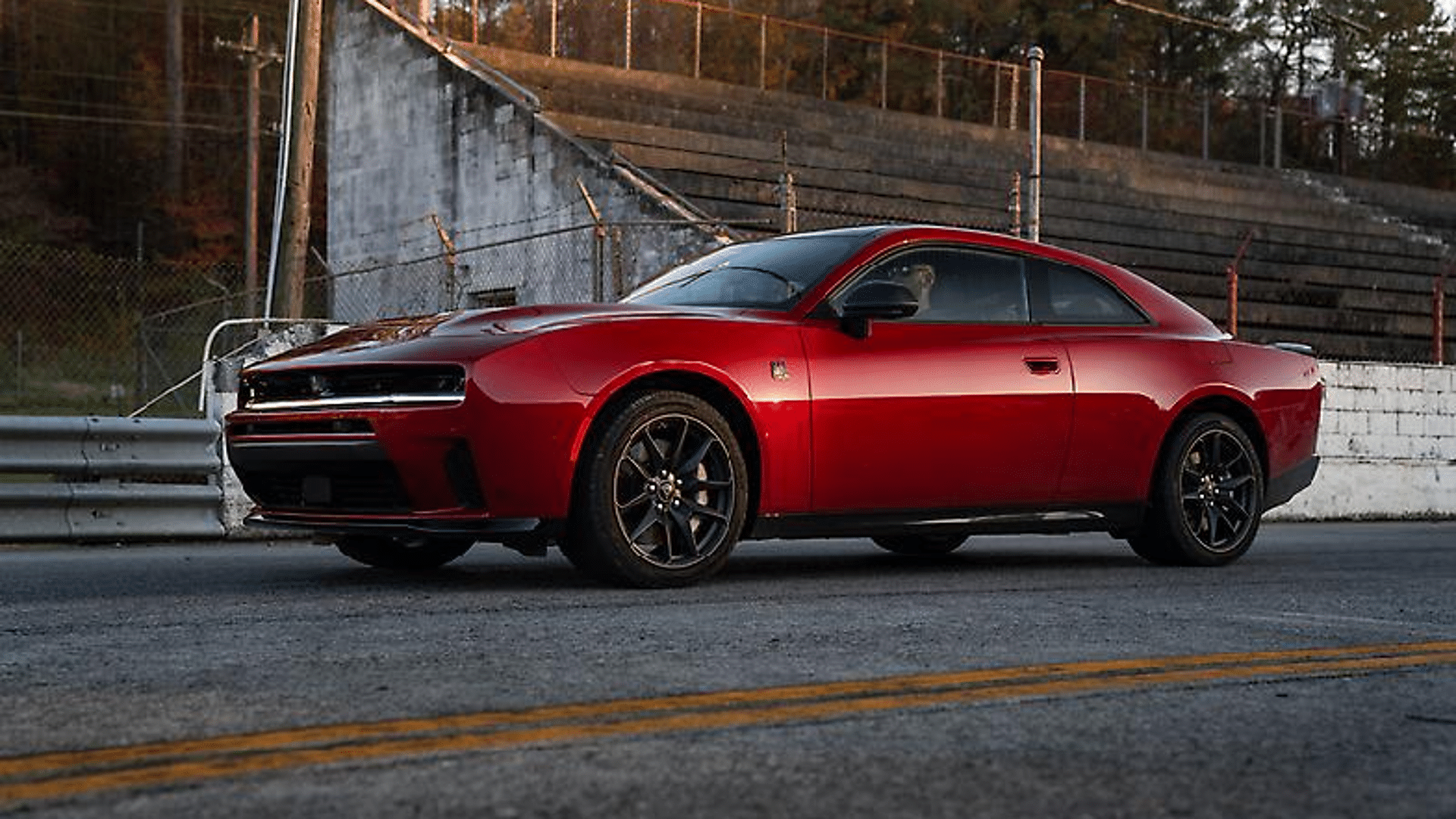 Red Dodge Charger two-door coupe parked on a drag strip pit lane