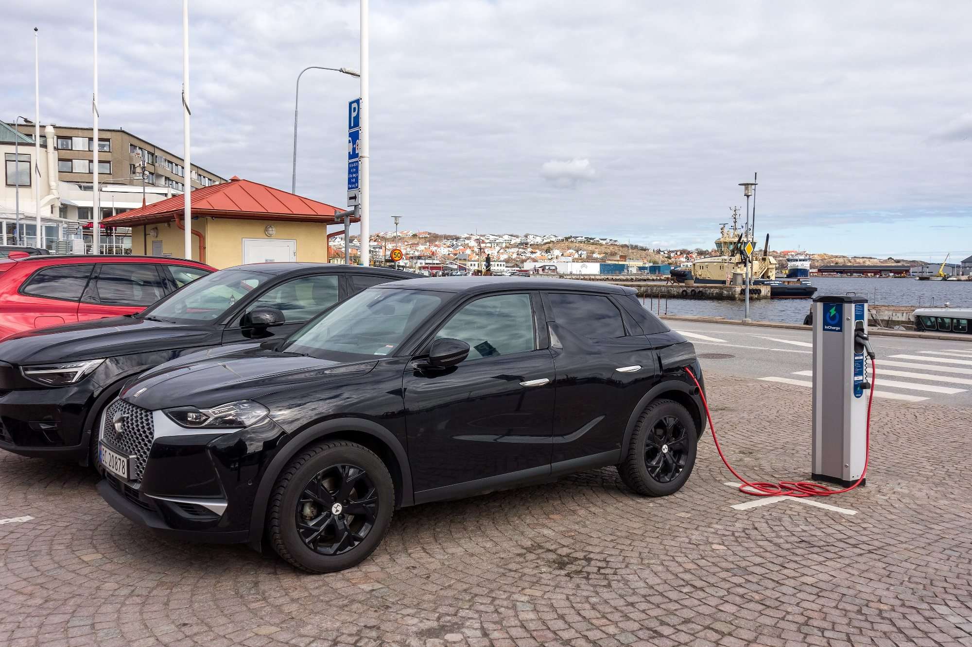 Electric cars plugged in at a charging station in the South Harbor of Lysekil, Sweden