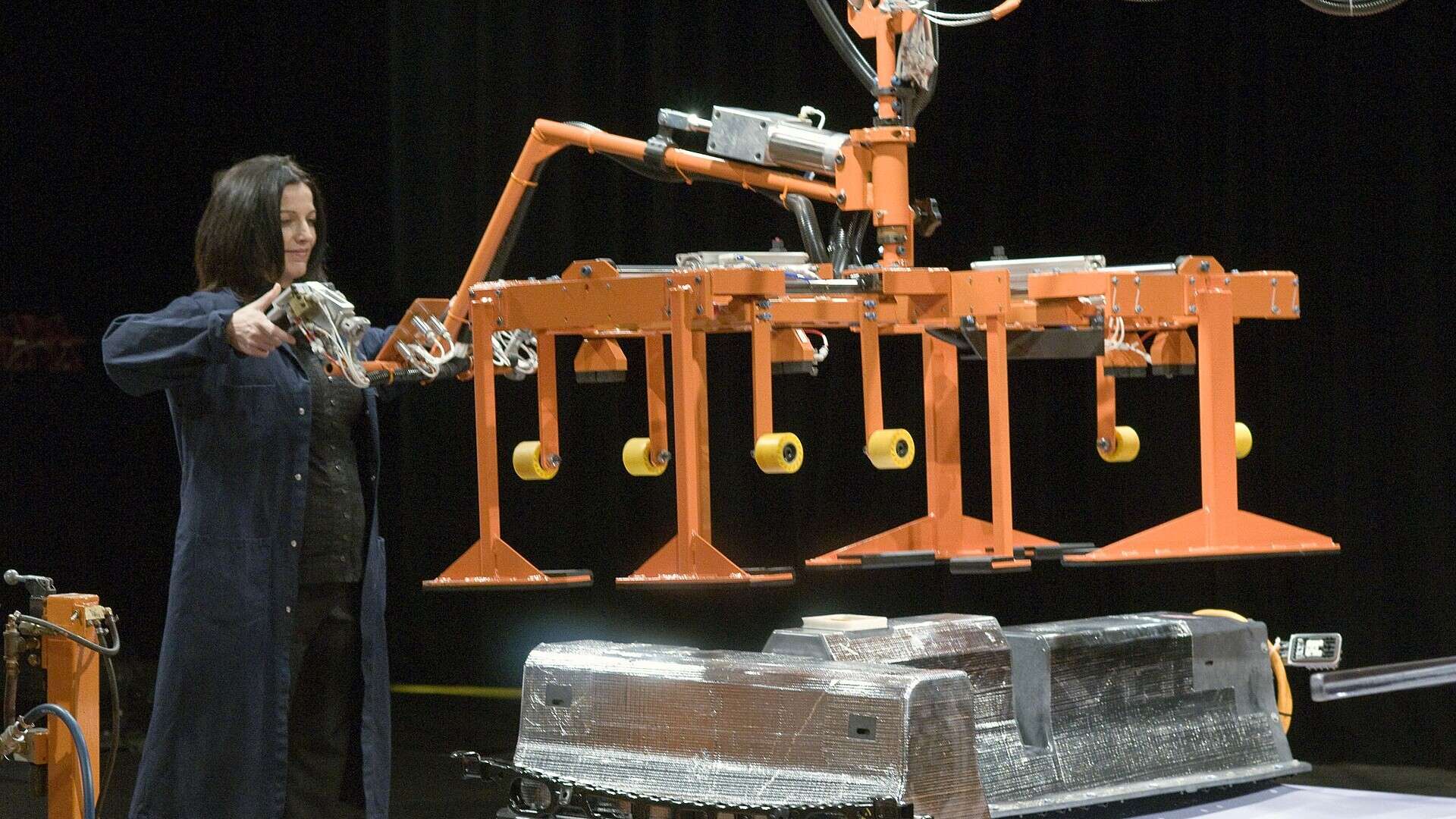 A GM plant manager pushes the first Chevrolet Volt lithium-ion battery pack off the assembly line at GM's Brownstown Township, Michigan, battery plant in January 2010