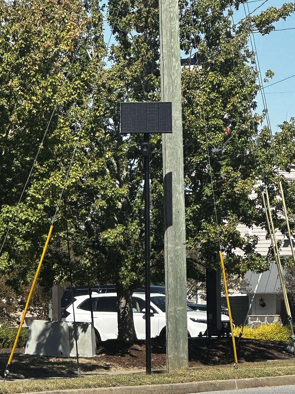 A Flock Safety license plate reader camera on a pole beside a road in Valdosta, Georgia