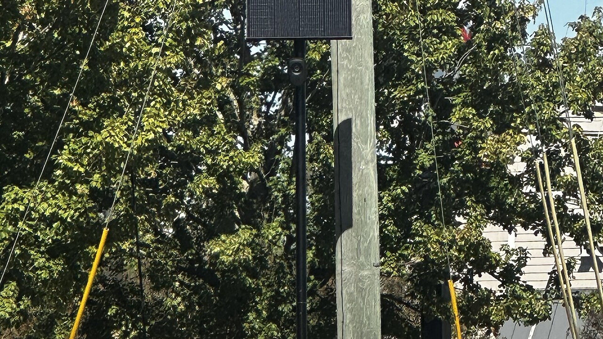 A Flock Safety camera with a solar panel on a pole in Valdosta, Georgia