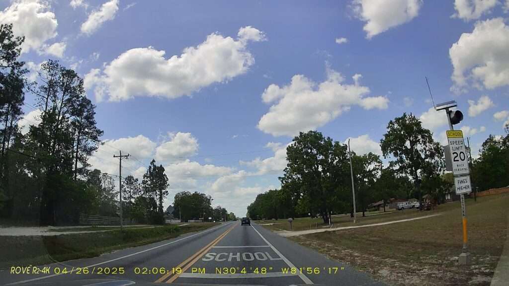 School zone pavement markings and a 20 mph school speed limit sign on County Road 218 in Clay County, Florida