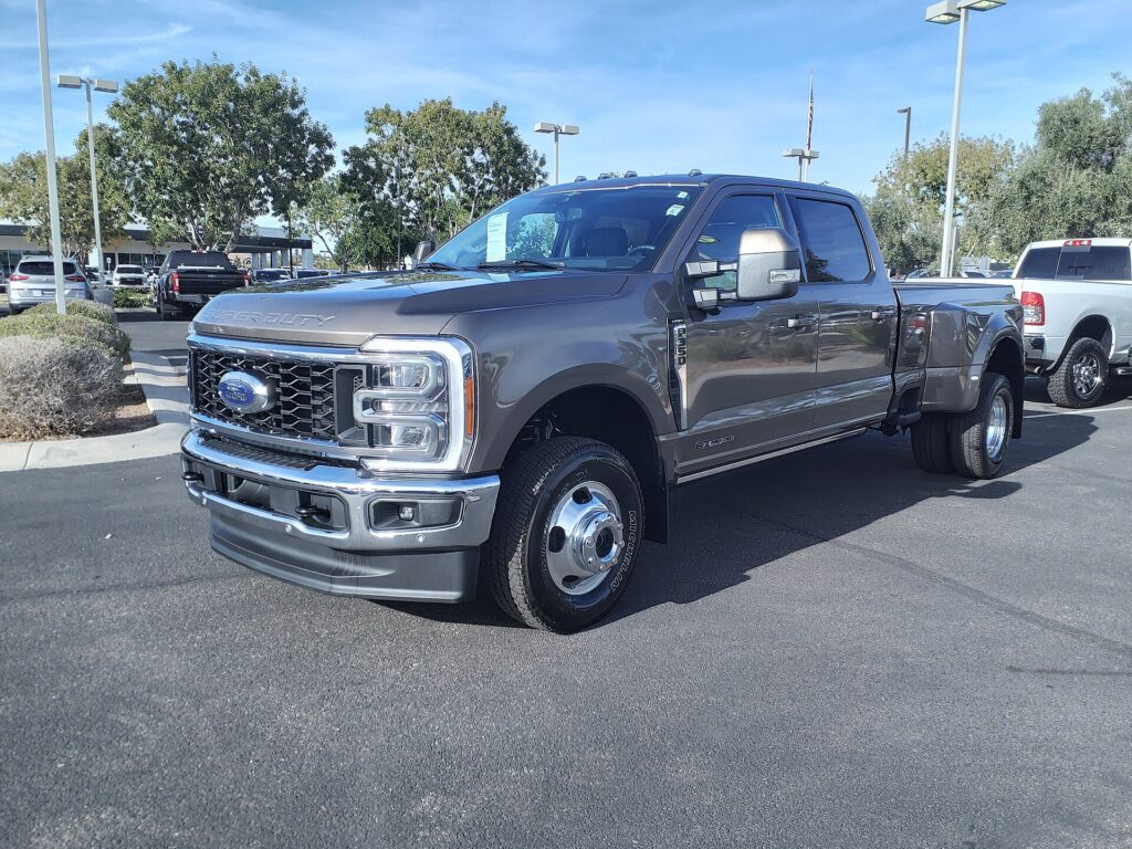 Gray 2023 Ford F-350 Super Duty Lariat dual-rear-wheel crew cab pickup parked on a dealership lot