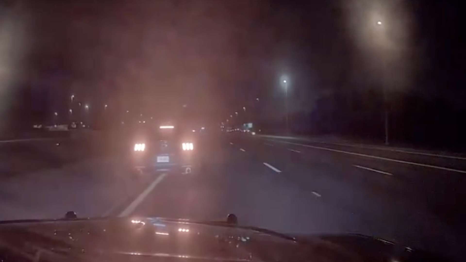 Night view from a Florida Highway Patrol dashcam on Interstate 4 near Tampa, with a car's brake lights ahead