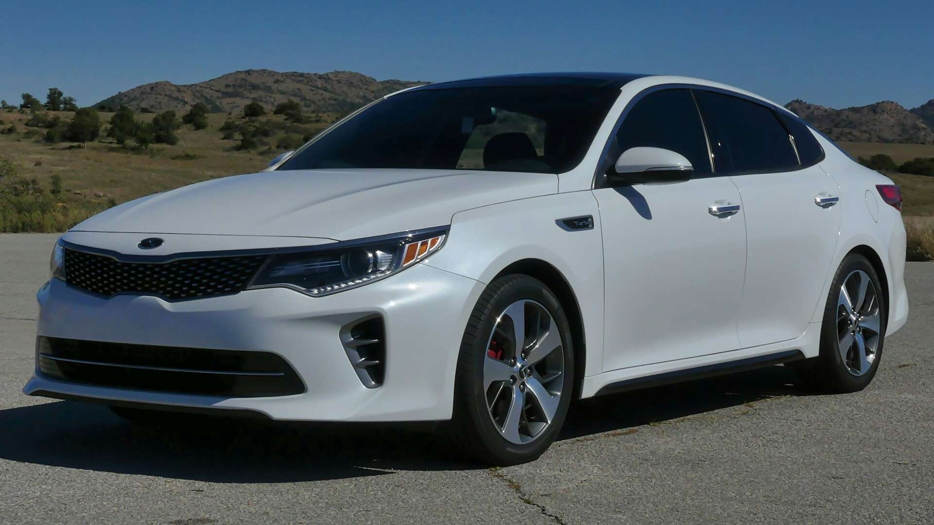 White 2016 Kia Optima sedan parked on pavement
