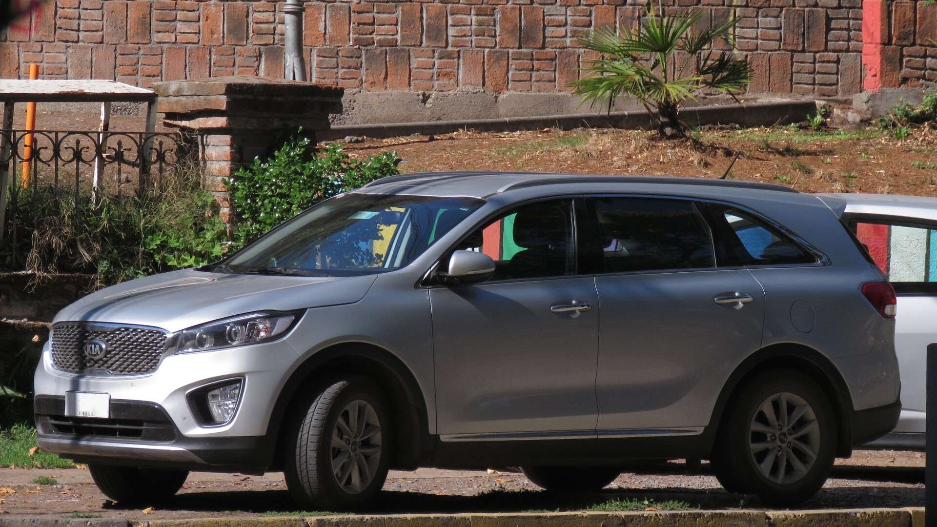Silver 2016 Kia Sorento EX SUV parked at a curb