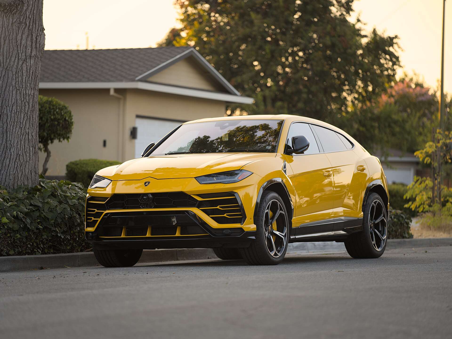 A Lamborghini Urus SUV photographed at dusk