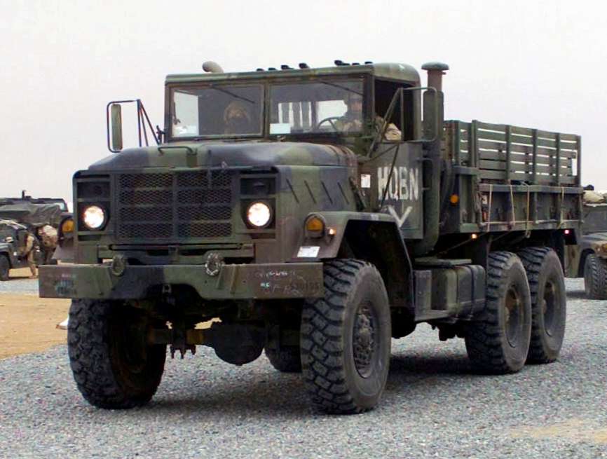 M923 6x6 five-ton military cargo truck leading a convoy
