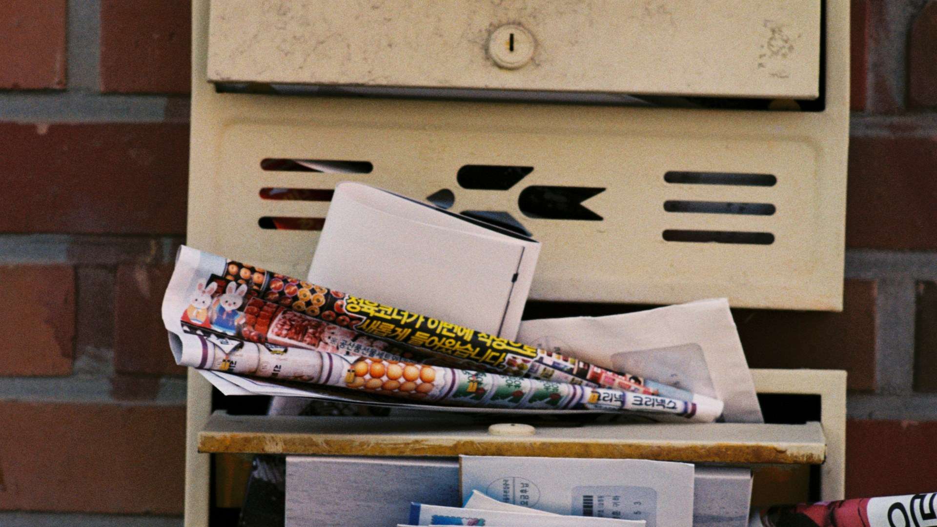 A mailbox stuffed with letters and mailers