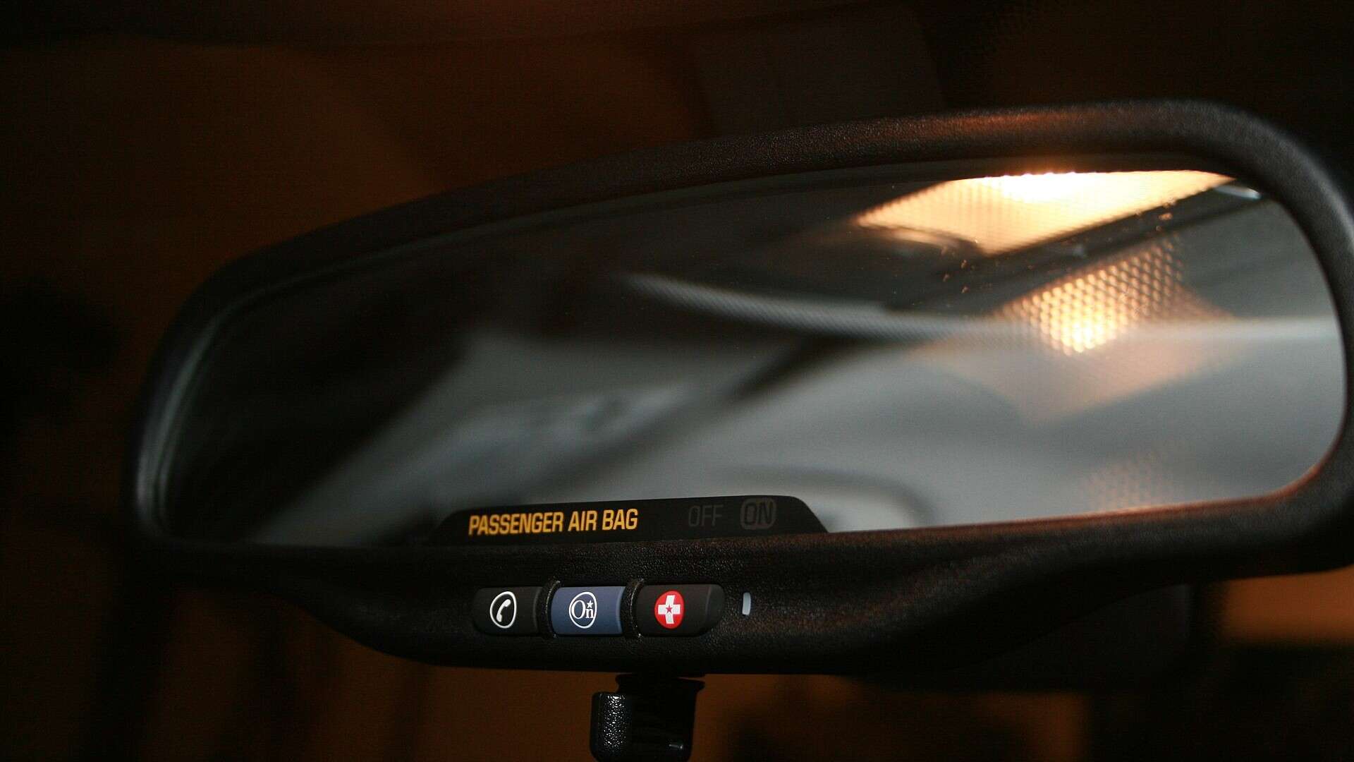 OnStar buttons beneath the rearview mirror of a GM vehicle, the system Montana says collected GM driving data