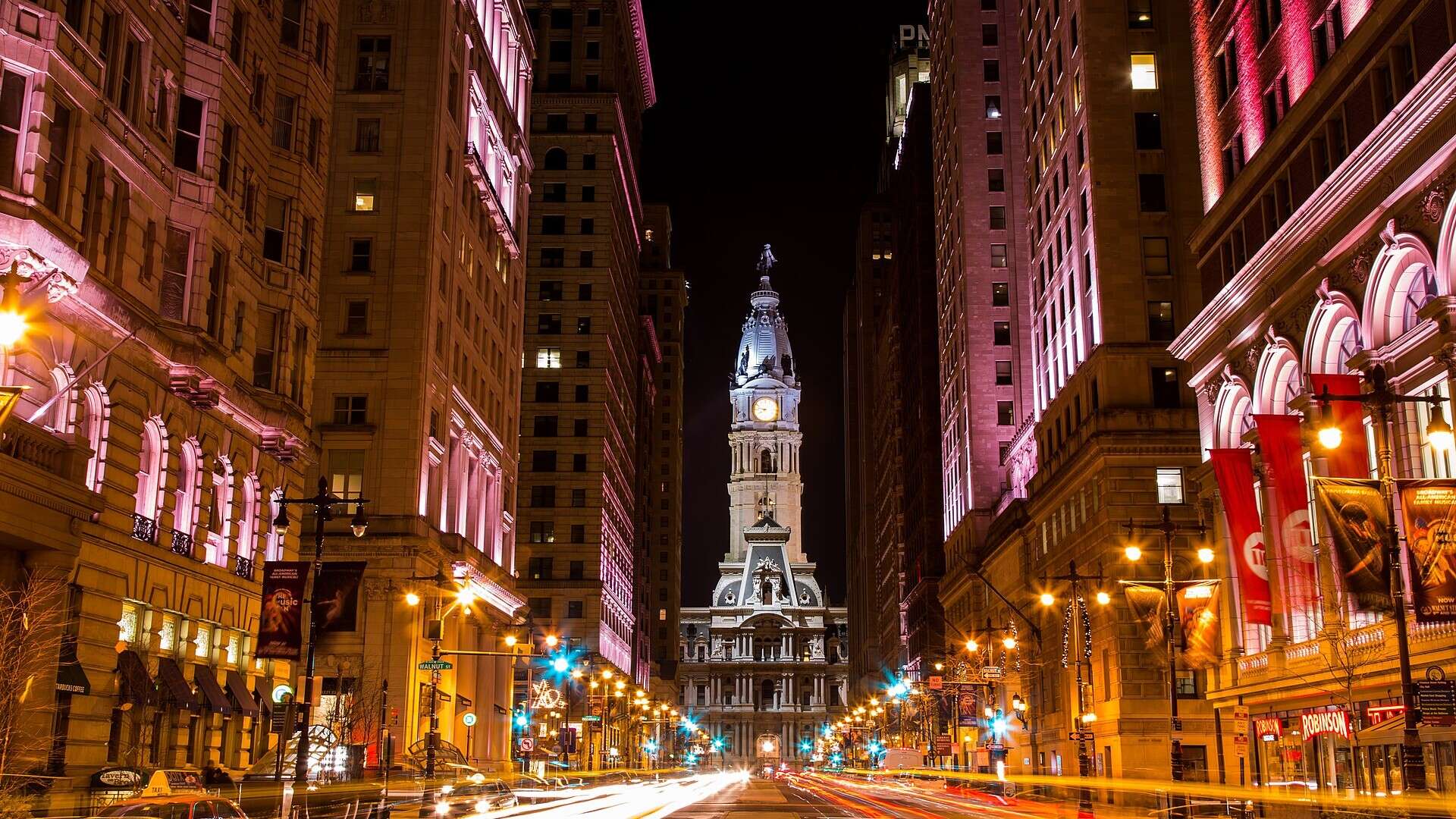 Philadelphia City Hall at night, seen up South Broad Street with light trails from passing traffic