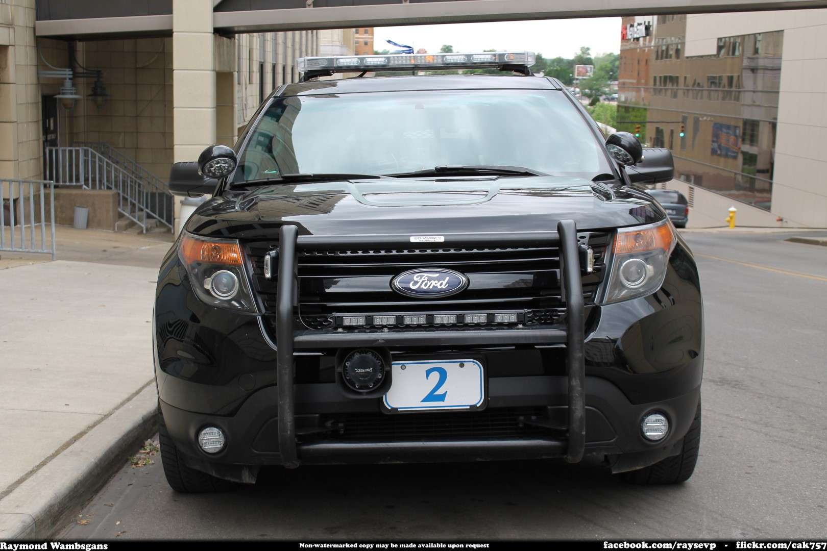 A marked police Ford Explorer Police Interceptor Utility parked at the curb