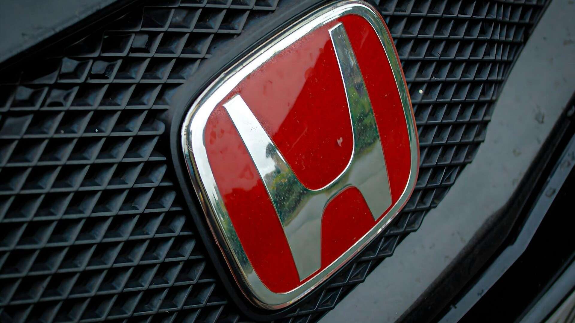 A close up of a honda emblem on a car