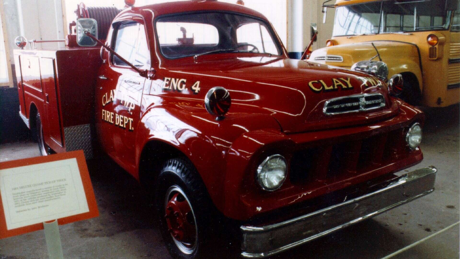 A vintage Studebaker fire truck and school bus on display at the Studebaker museum in South Bend, Indiana