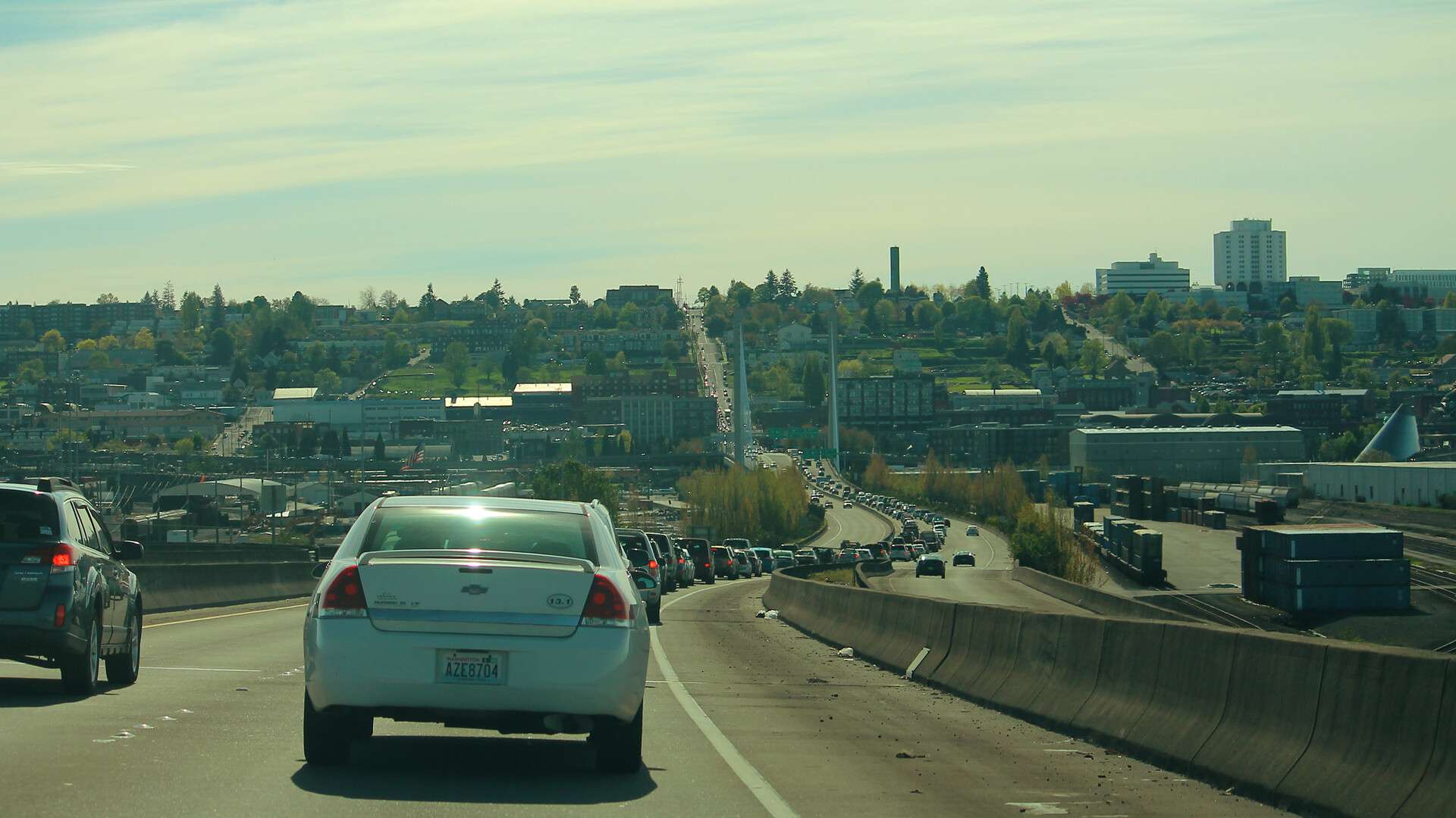 Cars driving on State Route 509 in Tacoma, Washington, with the city skyline ahead