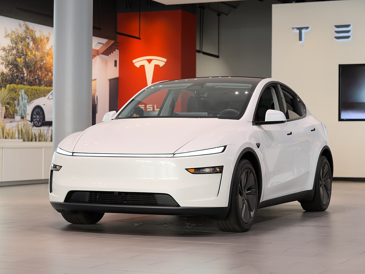 Tesla Model Y parked on a city street, one of the EVs behind the $55,879 average EV price