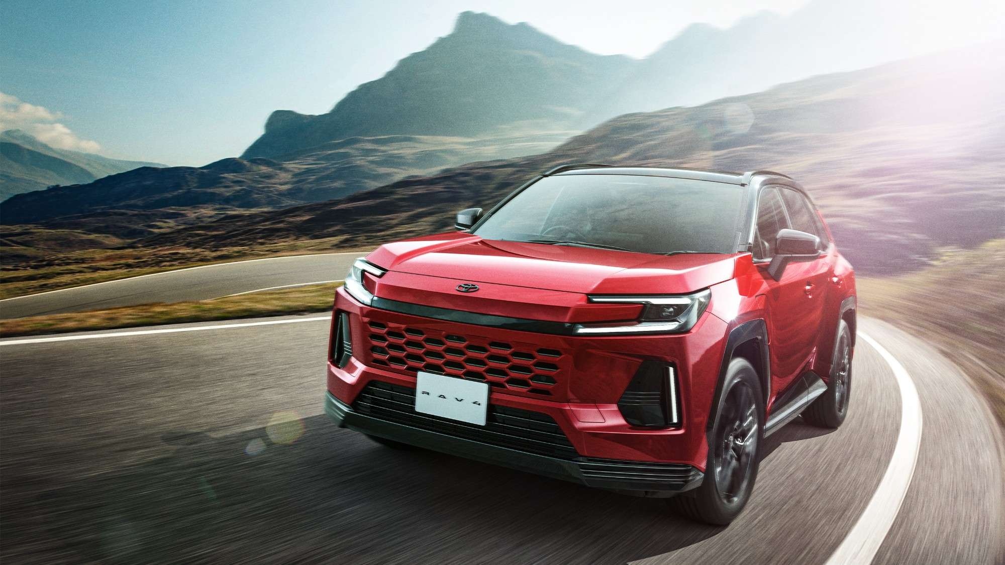Red Toyota RAV4 plug-in hybrid on a coastal road