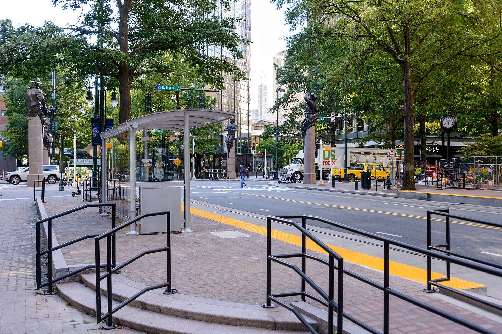 Tryon Street in uptown Charlotte, North Carolina, with a transit shelter and high-rise towers