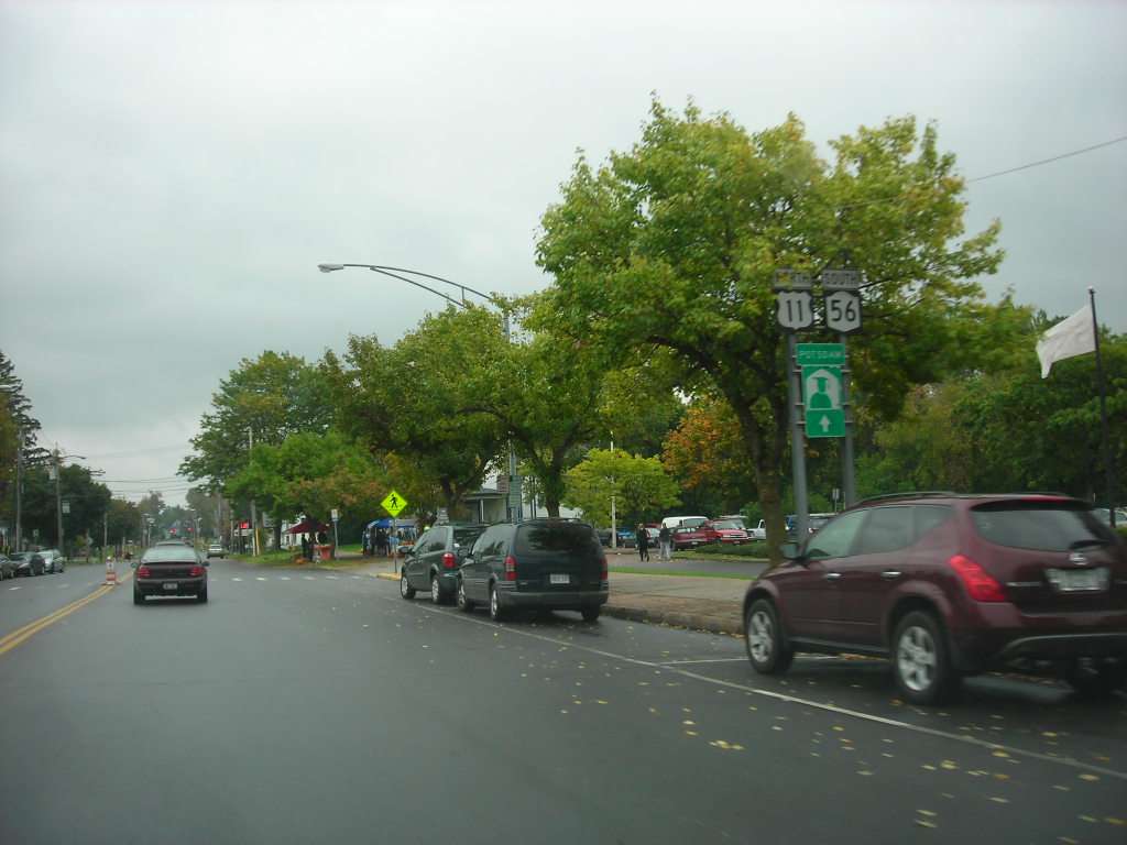Route shields for U.S. 11 and New York State Route 56 on a signpost in Potsdam, New York