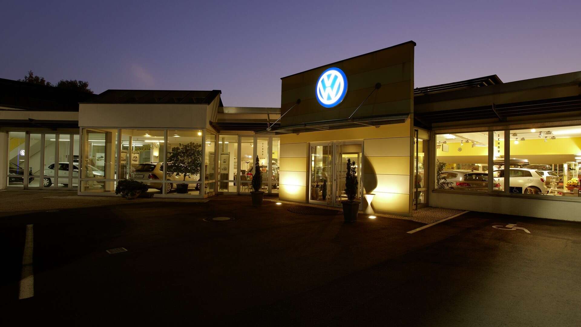 Volkswagen dealership in Ettlingen, Germany, lit up at dusk