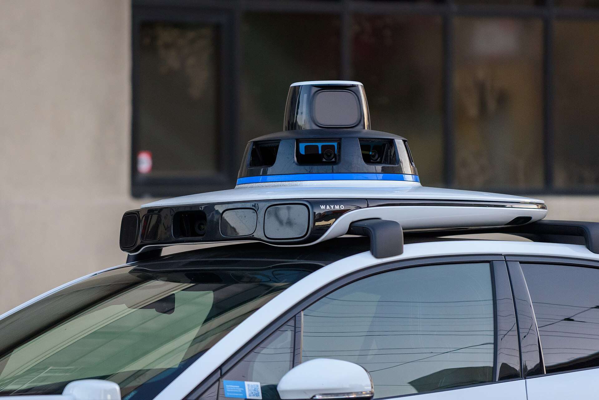 Close-up of the roof-mounted sensor dome on a Waymo Jaguar I-Pace